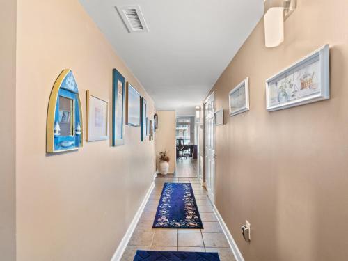 a hallway with a blue rug on the floor at Oceanfront Get Away in Myrtle Beach