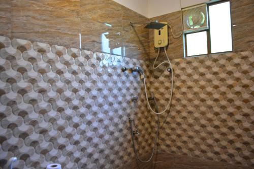 a shower in a bathroom with a shower curtain at Trinco Eddi Resort in Trincomalee