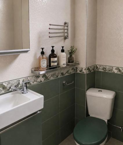 a bathroom with a toilet and a sink at Sea & Sun Grigoleti in Grigoleti