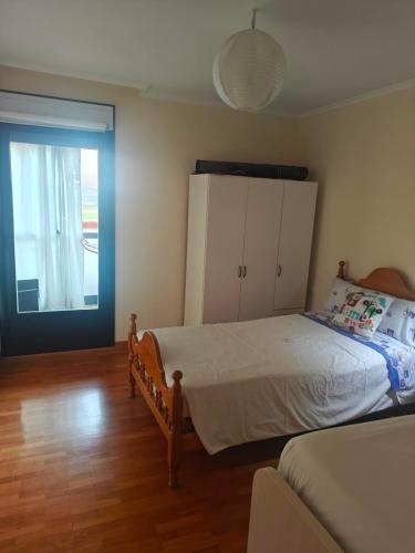 a bedroom with a bed and a sliding glass door at Apartamento cerca de Haro in San Vicente de la Sonsierra