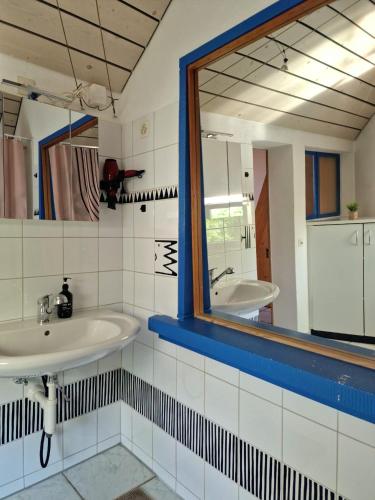a bathroom with two sinks and a mirror at Casa Maria West in Solothurn