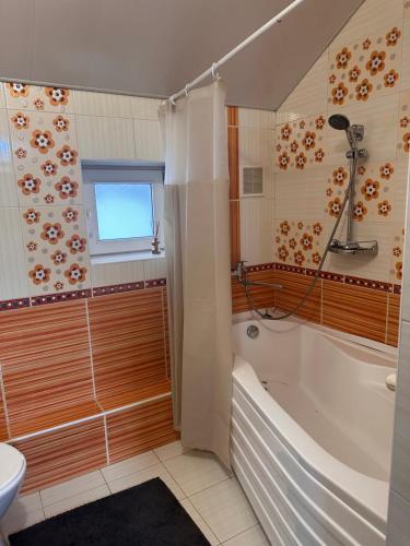 a bathroom with a tub and a toilet and a sink at Casa Centru Chișinău in Chişinău