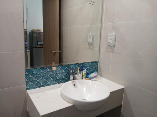 a bathroom with a white sink and a mirror at Marina vinhomes in Long Bình