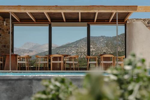a room with a view of the mountains through windows at Axopetra Boutique Hotel in Agiassos