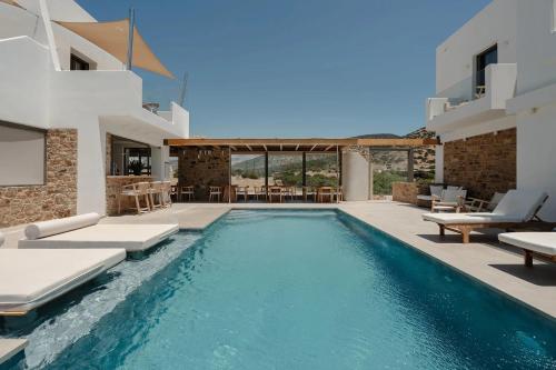 a villa with a swimming pool and a patio at Axopetra Boutique Hotel in Agiassos