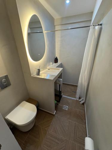 a bathroom with a toilet and a sink and a mirror at EVE's house 6 - Corinth center loft in Korinthos