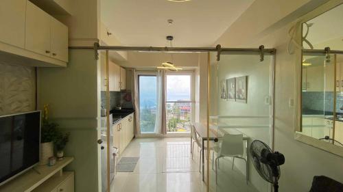 a kitchen with a large glass door with a view at Casa Lumière in Tagaytay