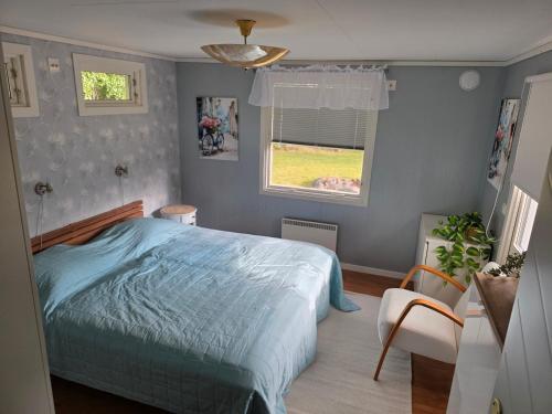 a bedroom with a large bed and a window at Smaland Trollsjö in Mönsterås