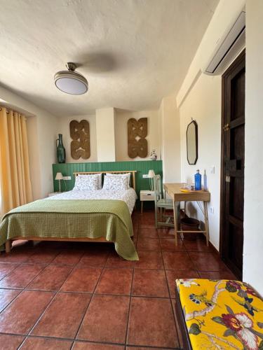 a bedroom with a bed and a table at Cortijo Cenascuras in Priego de Córdoba