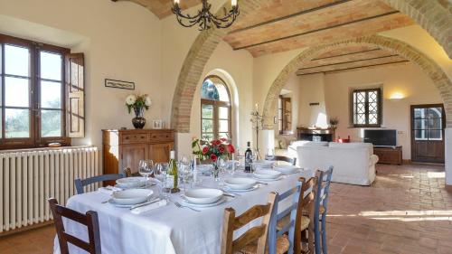 a dining room with a table with white table cloth at ALBORATA 10, Emma Villas in San Giovanni dʼAsso