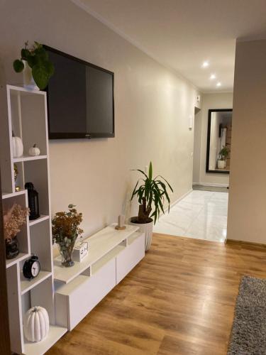 a living room with a flat screen tv on the wall at Mājīgie Apartamenti Saldū in Saldus