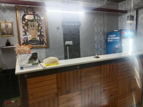 a counter in a store with a sign on the wall at Hotel Radhika Palace in Raipur