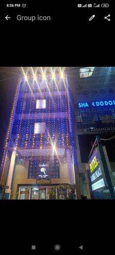 a tall building with blue lights on top of it at Hotel Radhika Palace in Raipur