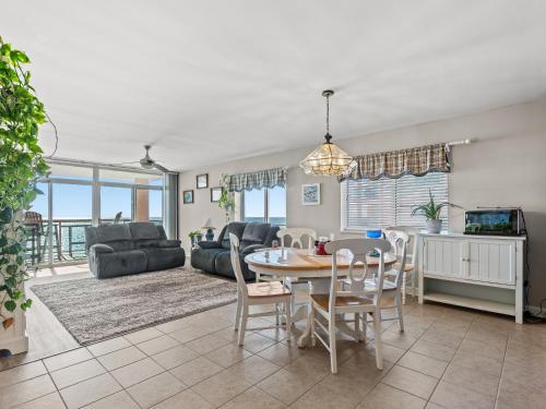 a dining room and living room with a table and chairs at Crescent Beauty in Myrtle Beach