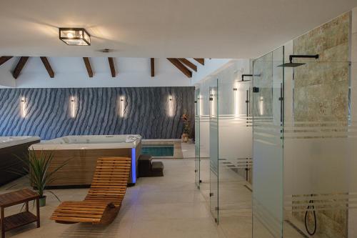 a bathroom with a bath tub and a bath tub at Generalis Wine Hotel in Tokaj