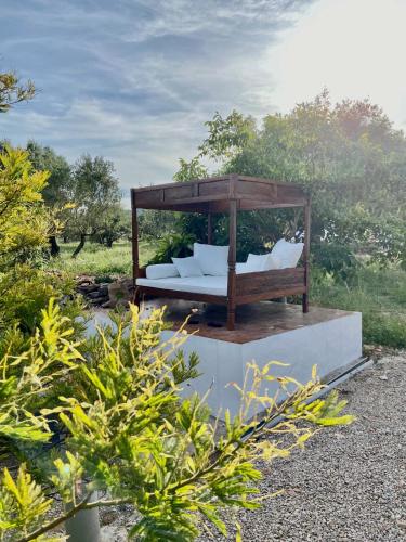 a bed with white pillows sitting on top at Can Mimosa Guesthouse in Tortosa