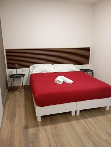 a bedroom with a bed with a red blanket at Borgo Mantova in Potenza