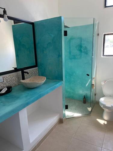 a bathroom with a sink and a glass shower at Departamento in Lo de Marcos