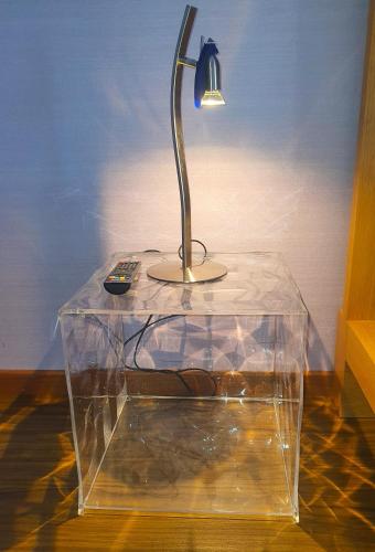 a glass table with a lamp on top of it at CAS Living Fátima in Fátima