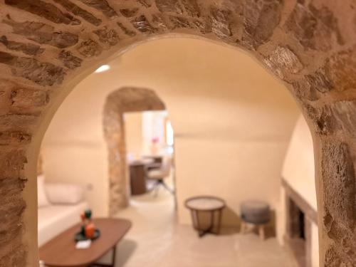 an archway in a room with a table and chairs at Opus Luxury Maisonette in Chios