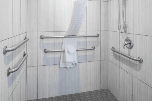 a bathroom with a shower with towels on the wall at La Quinta by Wyndham Moscow Pullman in Moscow