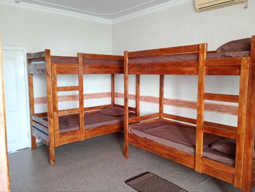 two wooden bunk beds in a room with at Hostel COMFORT in Mukacheve