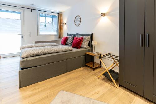 a bedroom with a bed and a clock on the wall at Ferienwohnung 2 Gasthaus Bußmann in Vreden