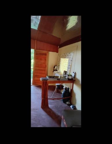 a room with a desk with a laptop on it at The Forest Cabin in Parrita