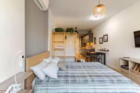 a bedroom with a blue and white bed with pillows at Studio Europa 30 in San Sebastián de los Reyes