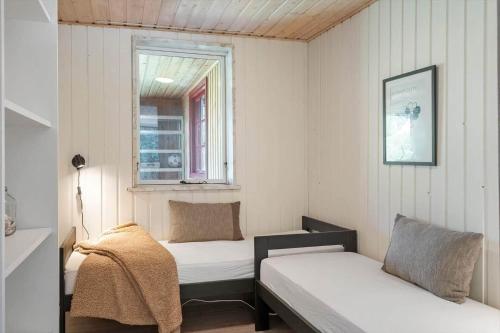 a small room with two beds and a window at LF12118-Vinderup-Vigen-18 in Handbjerg