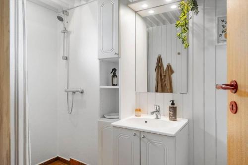 a white bathroom with a sink and a shower at LF12118-Vinderup-Vigen-18 in Handbjerg