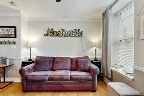 a living room with a purple couch in a room at Polk 401 in Nashville