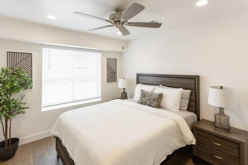 a white bedroom with a bed and a ceiling fan at Heated Pool & Pickleball - Spacious & Immaculate Home in Washington
