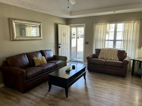 a living room with two leather couches and a coffee table at Mount Juliet Charmer in Hunters Store
