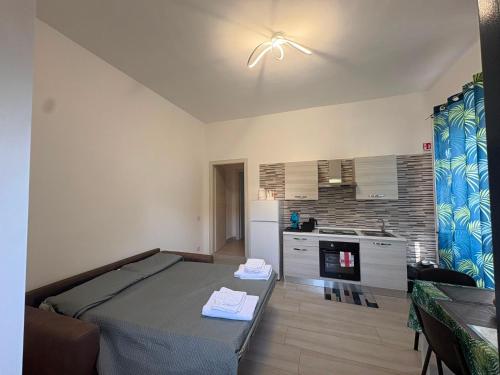 a room with a bed and a kitchen in it at Casa Concettina in Ercolano