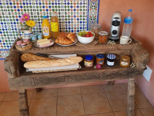 a table with bread and other food on it at L'Hacienda in Mialet