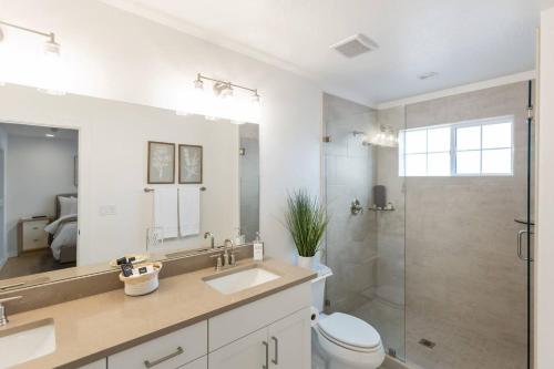 a bathroom with a toilet and a sink and a shower at Heated Pool & Pickleball - Spacious & Immaculate Home in Washington