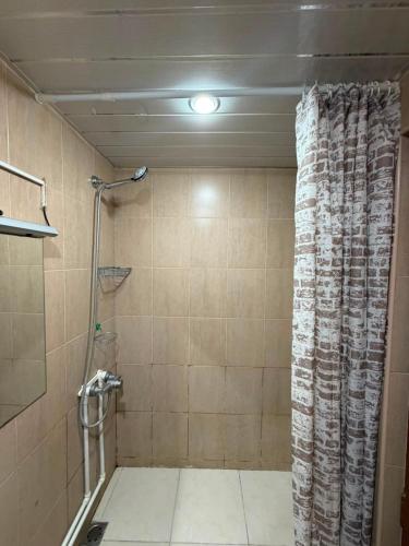 a bathroom with a shower with a shower curtain at D&A hotel in Yerevan