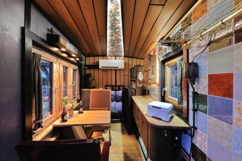a train car with a table and chairs in it at Tiny Boat Berta in Ottenbüttel