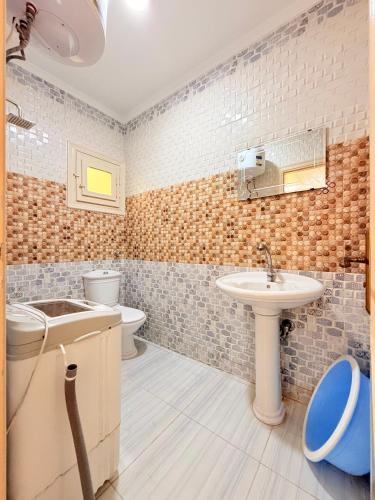 a bathroom with a sink and a toilet at Halla season matrouh in Marsa Matruh