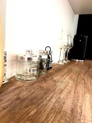 a group of glass jars sitting on top of a wooden floor at Oli' Studio in Oropos