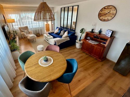 a living room with a table and a blue couch at Appartement de vacances - ski-in ski-out in Veysonnaz