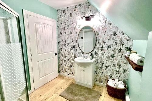 a bathroom with a sink and a mirror on a wall at Fin's Studio, Fundy Park in Alma