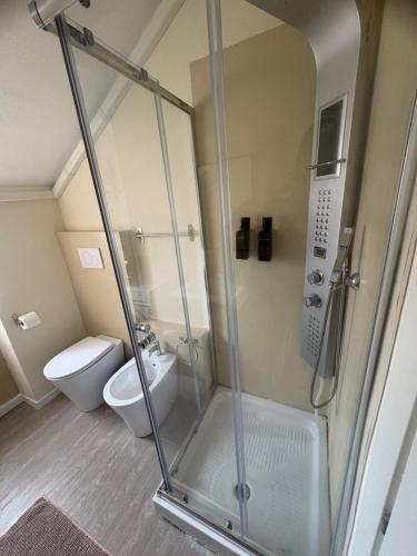 a bathroom with a shower and a toilet at La Concordia Serravalle Outlet in Serravalle Scrivia