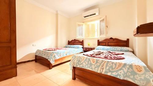 a bedroom with two beds and a window at Halla season matrouh in Marsa Matruh