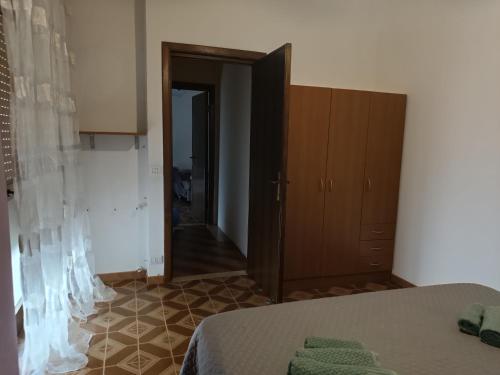 a room with a bed and a cabinet and a hallway at Azzurra Haven in Berchidda