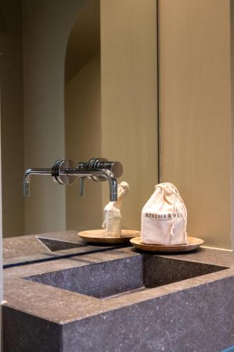 a hat sitting on a counter in front of a sink at B&B 't Wit Huys Brugge in Bruges