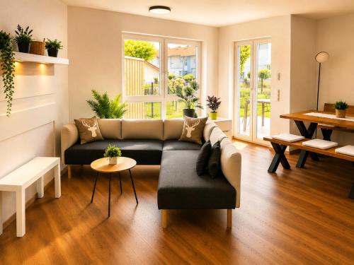 a living room with a couch and a table at Schongau Suites Premium Apartments XL in Schongau