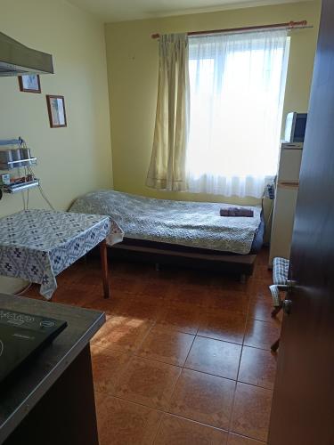 a room with two beds and a window at VIP in Ahtopol