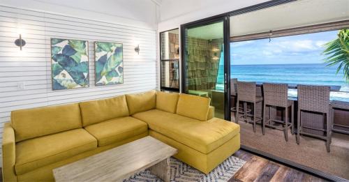a living room with a couch and a table at Modern-Rustic Beach Renovation Direct Oceanfront Penthouse in Kahana